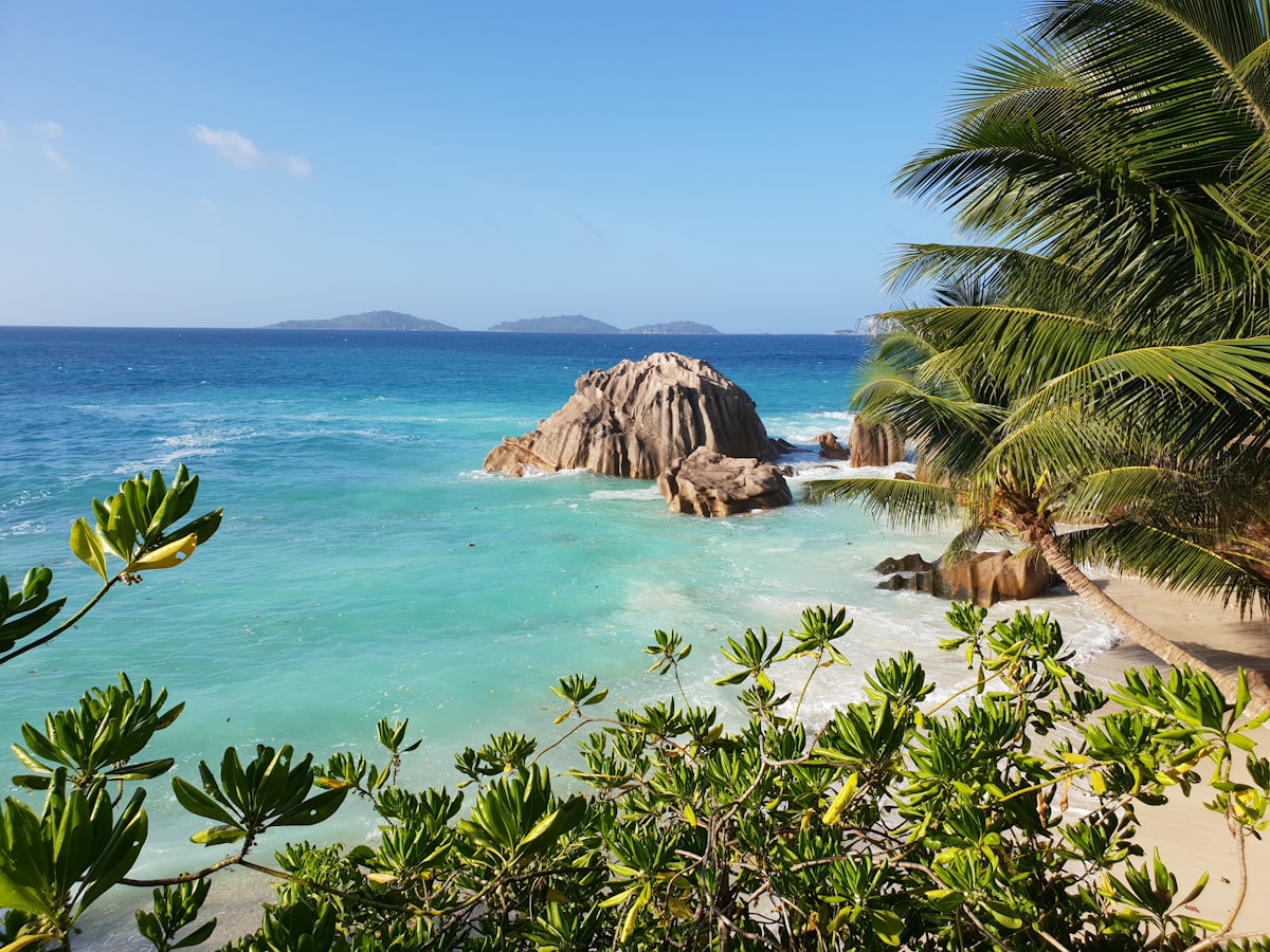 Giant granite boulders lining the pink-white sand of Anse Source d'Argent beach in Seychelles