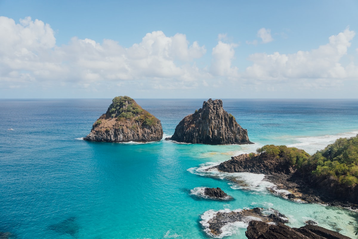 Secluded Baia do Sancho beach surrounded by green cliffs in Fernando de Noronha, Brazil