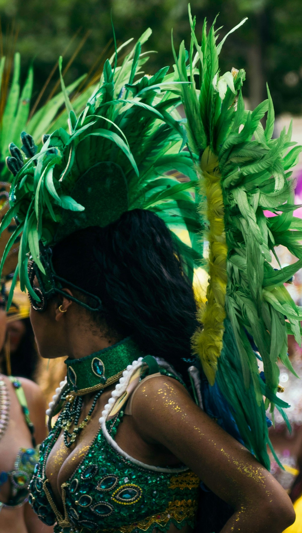 Vibrant Caribbean carnival celebration with dancers in colorful feathered costumes and headdresses