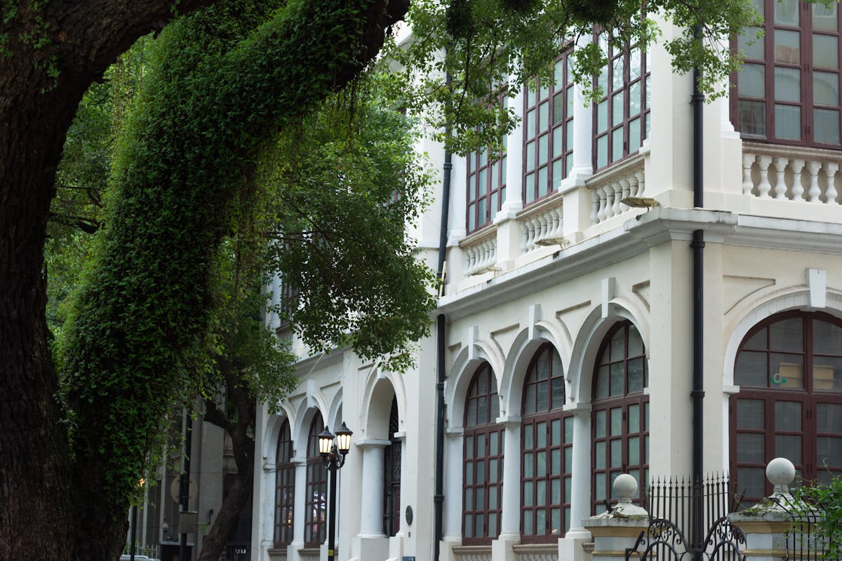 Tree-lined colonial European boulevard with historic buildings on Shamian Island in Guangzhou