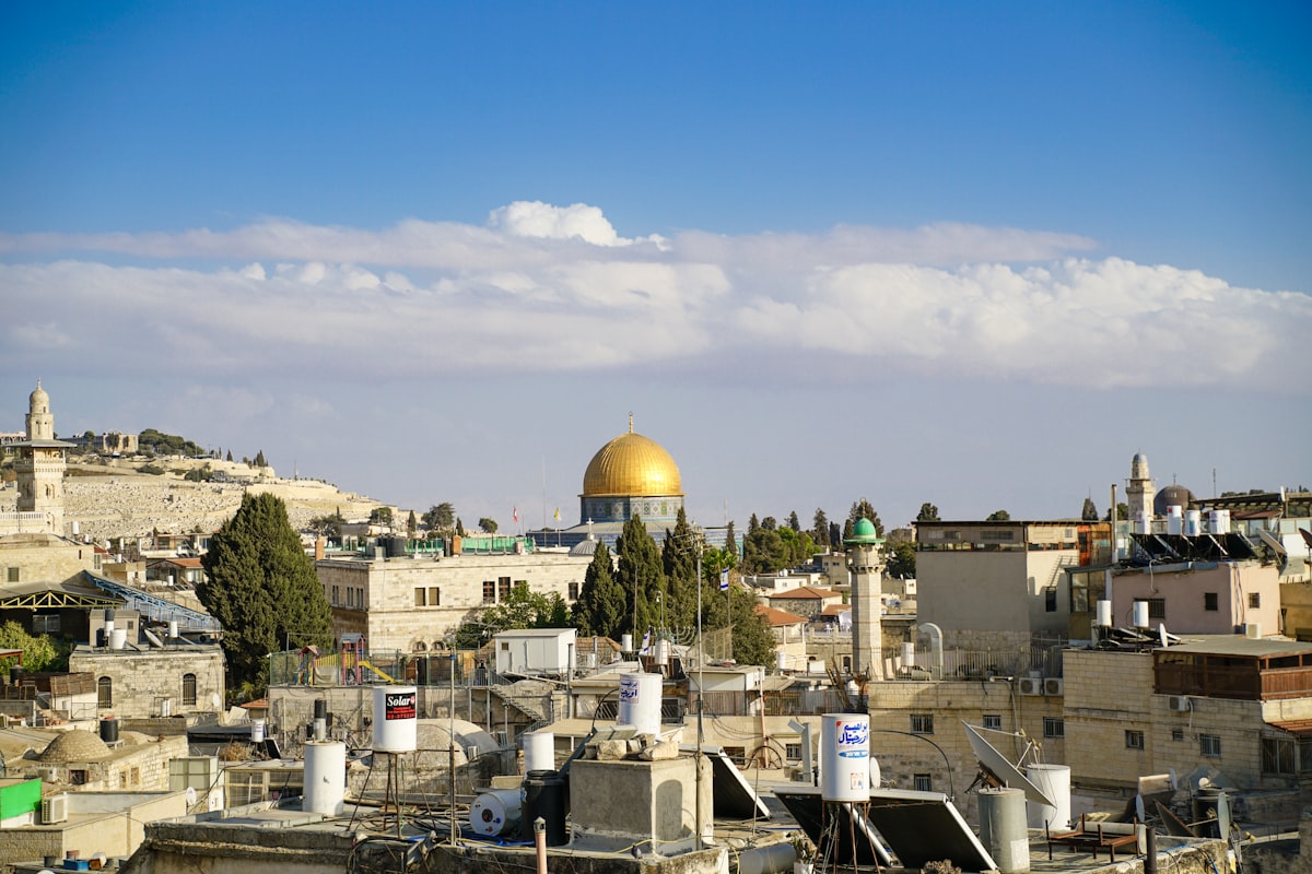 Jerusalem skyline at sunset showing the golden Dome of the Rock and ancient city walls