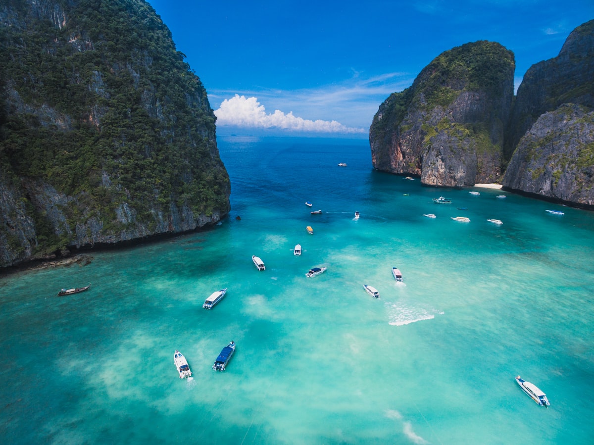Maya Bay on Phi Phi Leh island, Thailand, with emerald green water enclosed by steep limestone karsts